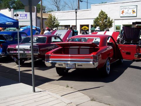 1972 Ford Ranchero - Rear view of a red 1967 Chevrolet Chevelle SS at a car show, with a Ford Mustang nearby.