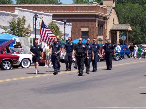 1972 Ford Ranchero - First responders and vintage vehicles participate in a community parade on a sunny day.