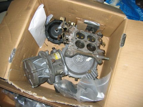 1992 Ford Mustang - Carburetor and fuel pump parts in a cardboard box, ready for installation or shipping.