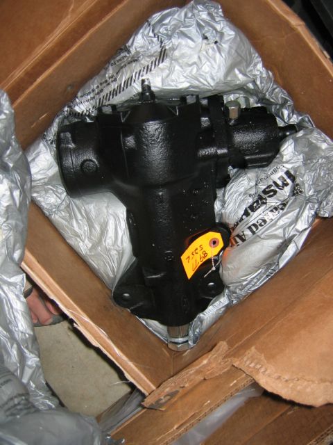 1992 Ford Mustang - A new steering gear box is shown packed in its shipping box, ready for installation.