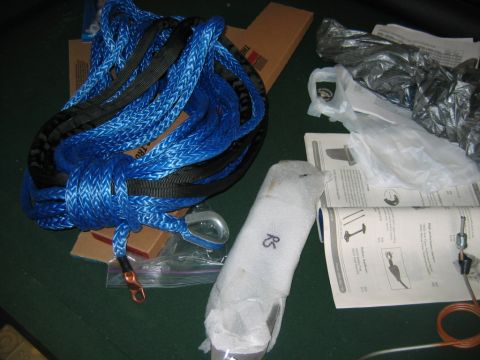 1992 Ford Mustang - A blue tow strap and installation instructions are laid out on a dark surface.