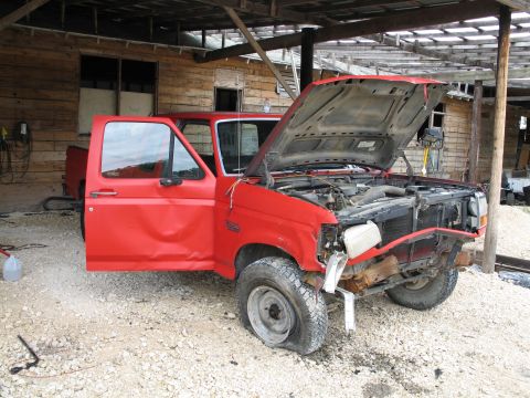 1995 Ford Bronco - This 1995 Ford Bronco shows significant damage to the front end and driver's side door, with a flat tire.
