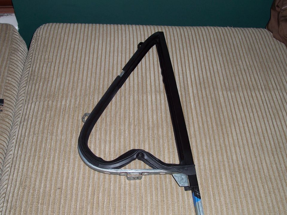 Window frame seal with rubber gasket and metal mounting bracket