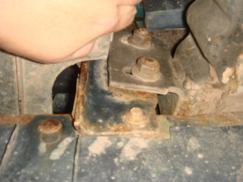 Rusted metal bracket with bolts, part of a winch installation