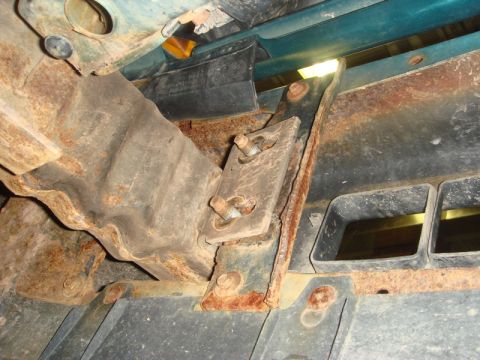 1996 Ford Bronco - Close-up view of a rusted front frame bracket on a 1996 Ford Bronco, likely related to a winch installation.