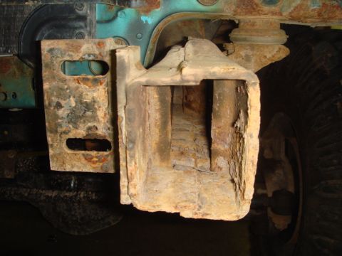 1996 Ford Bronco - Close-up of a heavily rusted winch mount bracket, showing significant corrosion on the vehicle's frame.