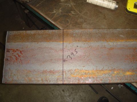 1996 Ford Bronco - Metal plate marked with a line and angle measurement, likely for fabrication.