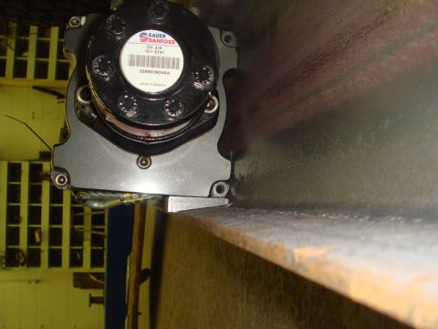 1996 Ford Bronco - Close-up of a Sauer-Danfoss motor mounted on a structural steel beam.