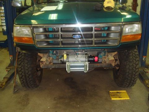 1996 Ford Bronco - A 1996 Ford Bronco is shown on a lift with a winch installed on its front bumper.