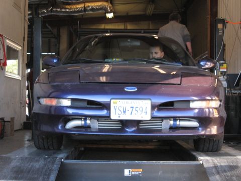 1996 Ford Probe - Front view of a purple 1996 Ford Probe with aftermarket intercoolers, positioned on a vehicle lift.