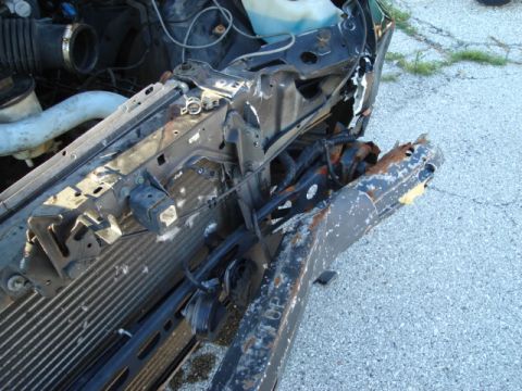 1992 Ford Crown Victoria - The front end of a 1992 Ford Crown Victoria shows significant damage to the bumper and radiator support.