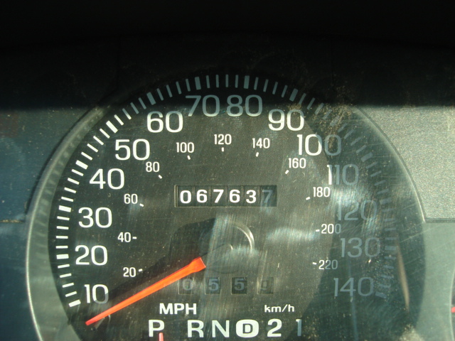 Car speedometer showing 0-100 MPH and odometer reading 067637. Gear selector shows P, R, N, D, 2, 1