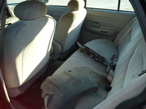 1992 Ford Crown Victoria - Interior of a car with parts on the back seat and floor.