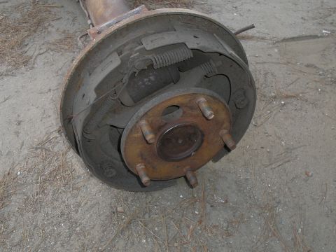1990 Ford Bronco - Close-up of a rear axle drum brake assembly, likely from an older vehicle.