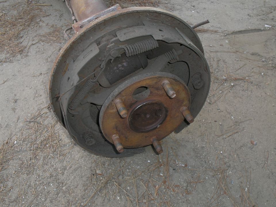 Rear axle drum brake assembly with five lug nuts visible
