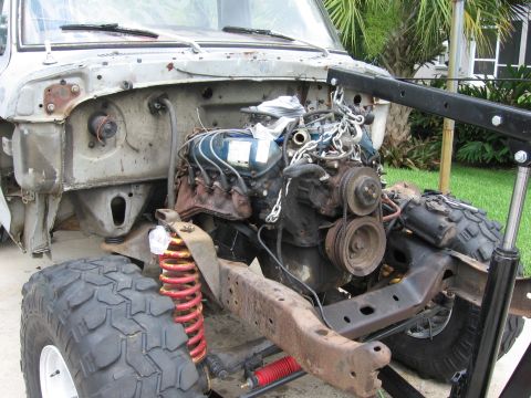 1974 Ford F-100 - The engine is suspended by a chain and hoist, ready for removal from the truck's frame.