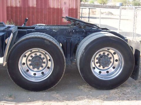 1981 Kenworth W900A - Close-up view of the dual rear wheels and chassis of a semi-truck.