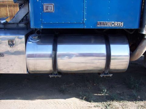 1981 Kenworth W900A - Side view of a blue Kenworth truck, highlighting its large chrome fuel tank and exhaust system.