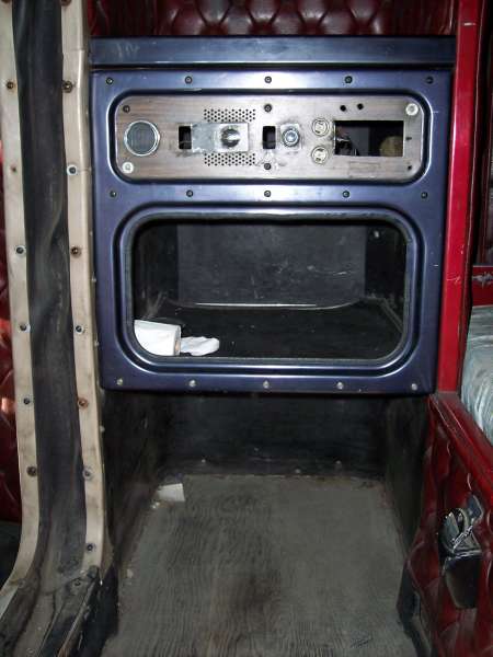1981 Kenworth W900A - View of the empty dashboard and storage compartment inside a truck's cabin.