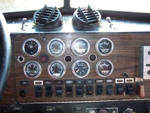1981 Kenworth W900A - Dashboard gauges and controls in a truck's interior.