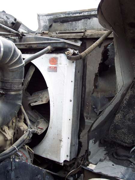 1981 Kenworth W900A - Close-up view of the engine bay, showing the radiator, fan, and some hoses. Caution labels are visible on the radiator shroud.