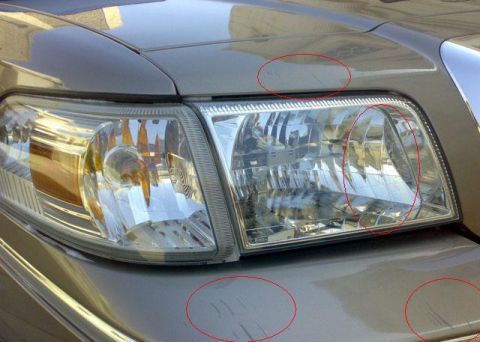 2007 Mercury Grand Marquis - Scratches are visible on the front bumper and hood of this 2007 Mercury Grand Marquis.