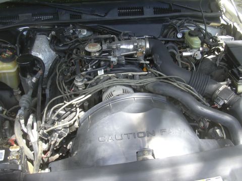 1997 Ford Crown Victoria - The engine bay features a prominent fan shroud with a caution warning, alongside a Supermotors.net watermark.