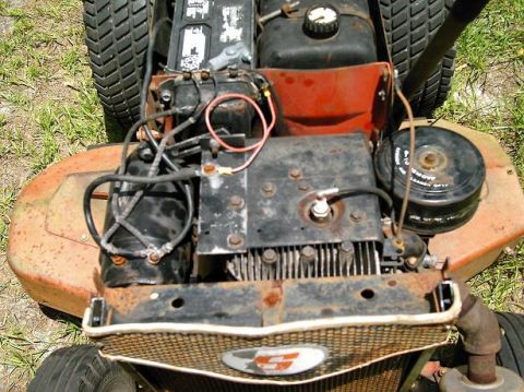 1986 Ford Bronco - Close-up view of a lawn mower engine, showing its various components and signs of wear.