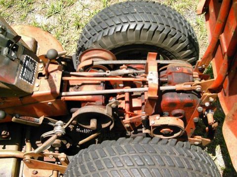 1986 Ford Bronco - The complex mechanical workings of a lawn mower's engine and drivetrain are visible in this close-up view.