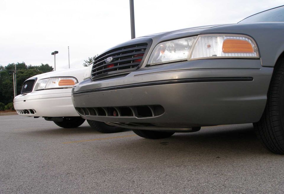 Two 2001 Ford Crown Victorias parked side-by-side, front view