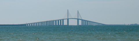 1997 Ford Crown Victoria - The Sunshine Skyway Bridge spans across the water, its distinctive cable-stayed towers visible in the distance.
