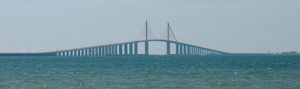 Sunshine Skyway Bridge over blue water under a hazy sky