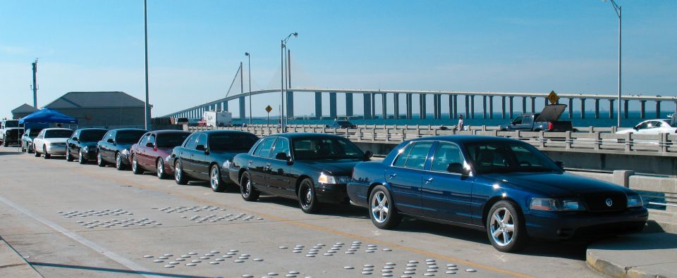 Blue 1997 Ford Crown Victoria in a line of sedans on a bridge