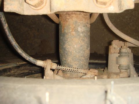 1996 Ford Bronco - Close-up view of the rear axle and brake components of a vehicle.