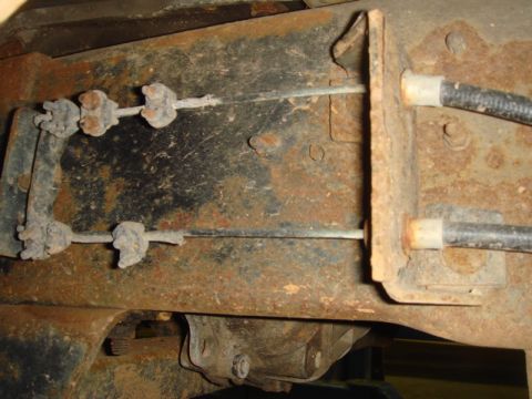 1996 Ford Bronco - Close-up view of the rear brake cables and frame components.