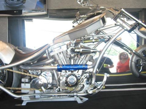 1988 Ford Bronco - A custom chopper motorcycle is shown from the side, highlighting its engine and chrome details.