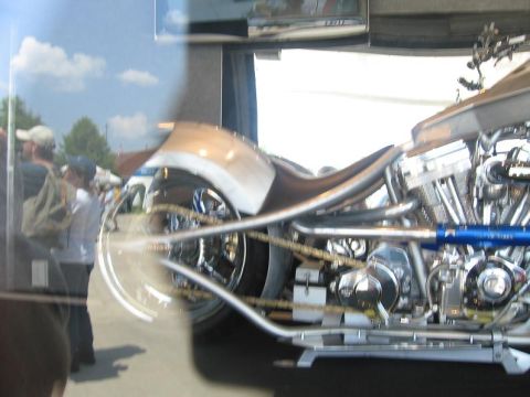 1988 Ford Bronco - A custom motorcycle with intricate chrome detailing and a powerful engine is displayed.
