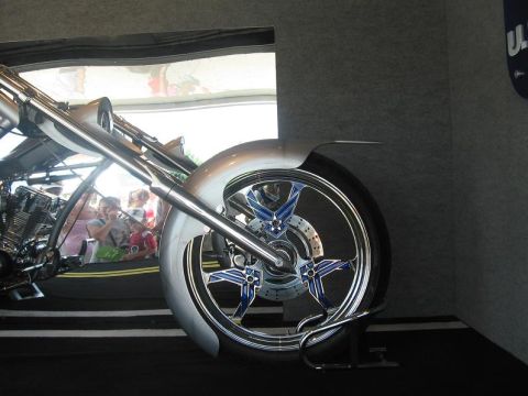 1988 Ford Bronco - Close-up of a custom motorcycle's front wheel and fender assembly.