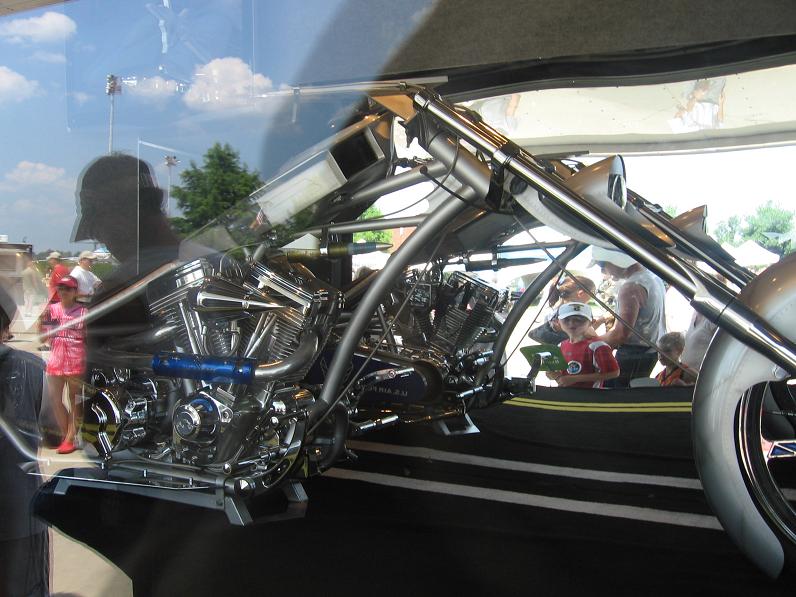 custom motorcycle with dual engines and chrome details, viewed from the side