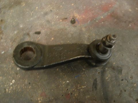 1992 Ford Crown Victoria - A Ford steering idler arm is shown with a part number stamped on its surface.