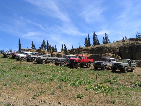 1979 Ford Bronco - A group of 1979 Ford Broncos and trucks gathered on a scenic mountain overlook.