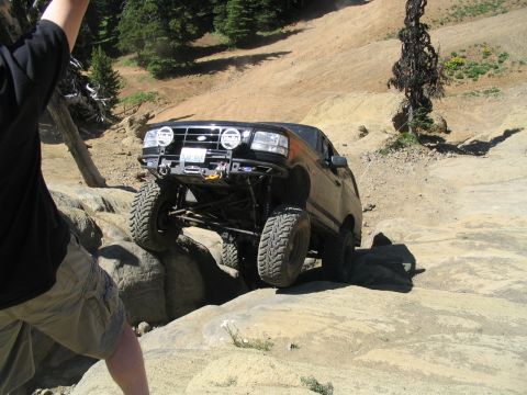1979 Ford Bronco - This modified Ford Bronco navigates a rocky trail, its front tires high off the ground.