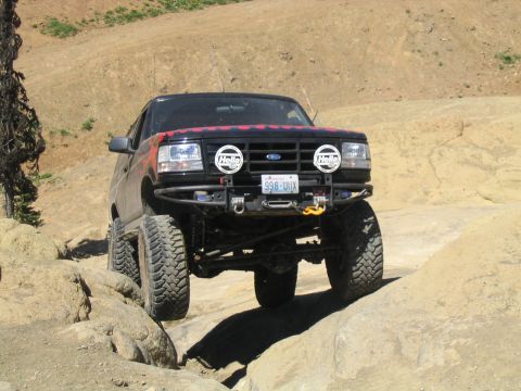1979 Ford Bronco - This modified Ford Bronco is navigating a rocky trail, its off-road capabilities.