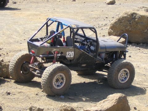 1979 Ford Bronco - Custom buggy with roll cage and off-road tires parked on rocky terrain.