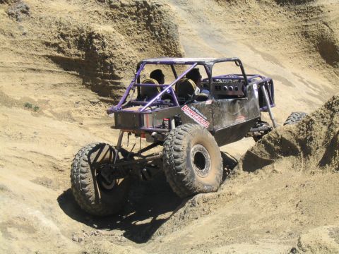 1979 Ford Bronco - This custom off-road buggy navigates a steep, sandy incline during an outdoor event.