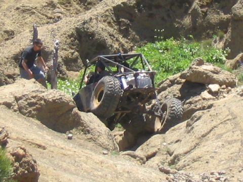 1979 Ford Bronco - A heavily modified off-road vehicle is shown traversing a challenging rocky landscape.