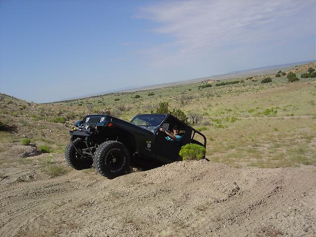 Black off-road vehicle on a dirt hill