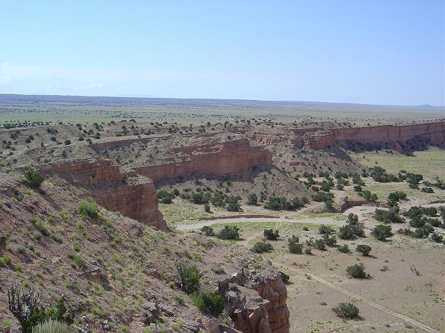 Desert landscape with mesas and sparse vegetation, Supermotors logo visible