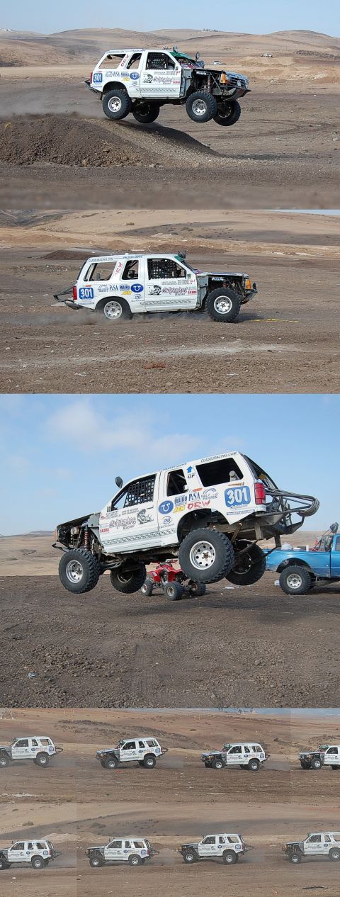 1992 Ford Explorer - Modified white SUV airborne during an off-road event, with multiple other vehicles in the scene.