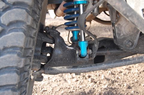 1992 Ford Explorer - Off-road suspension components, including a coilover shock and part of a tire, are visible.